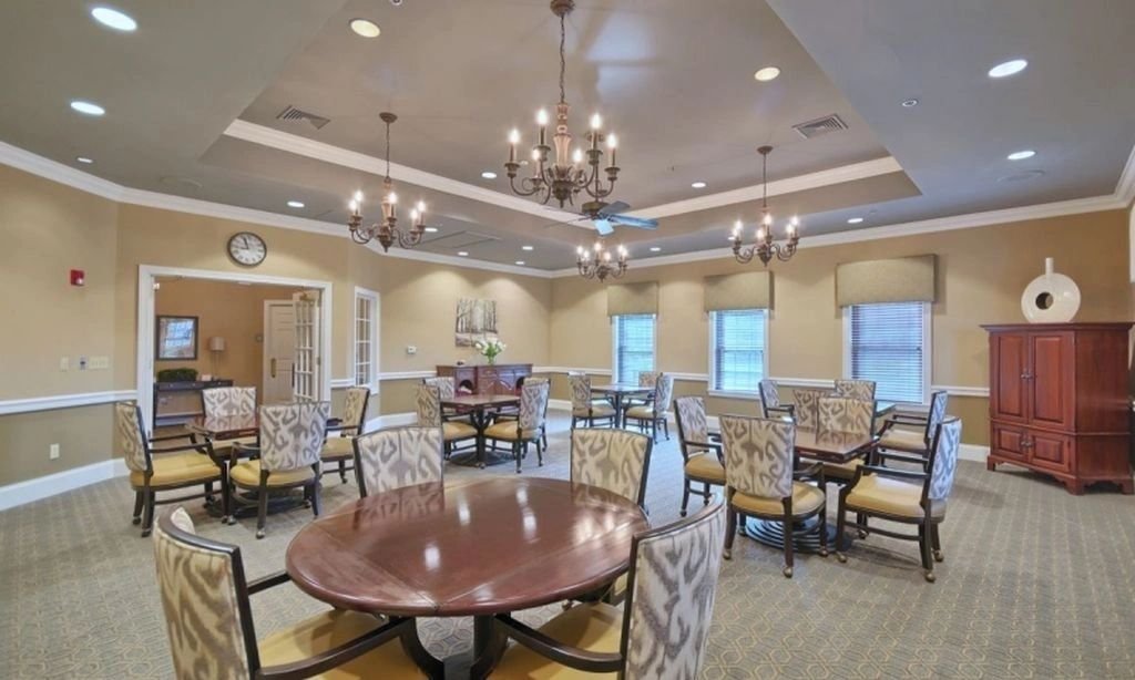 Riviera at East Windsor game and card room with round tables and patterned armchairs.